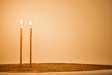 Two candles in sand