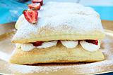 dessert cake of puff pastry, whipped cream and strawberries
