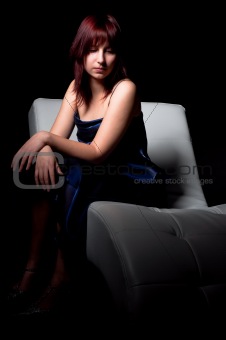 beautiful fashion woman in blue dress sitting