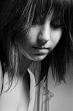 Beautiful young girl looking depressed in black and white