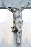 Stone cross with Jesus Christ crucifixion