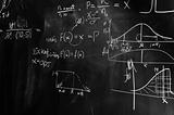 black and white picture of a chalk board with formulas