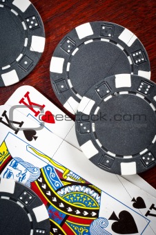 A pair of kings and some tokens on wood background