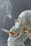 Skull with burning cigarette in mouth