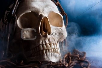 human skull with chain and smoke