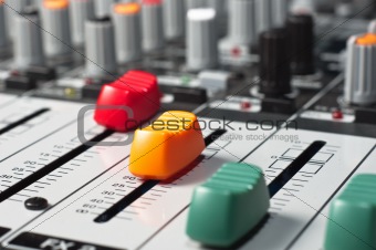 Part of an audio sound mixer with buttons and sliders