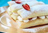 dessert cake of puff pastry, whipped cream and strawberries