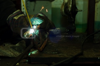 Welding in industrial enviroment with white sparks