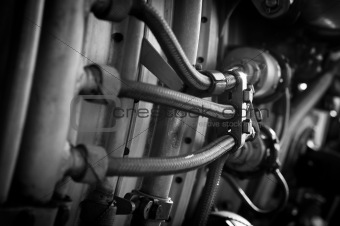 Jet engine part with hoses in black and white