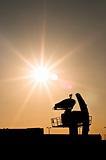 Silhouette of an old radar against sunset