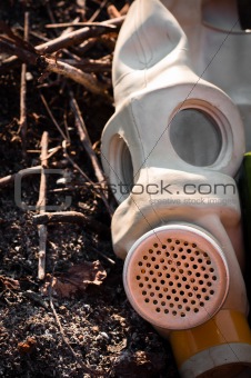 A gasmask on burnt ground