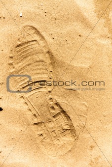 Closeup of a footprint in the sand