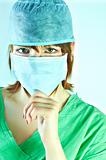 Woman surgeon holding her chin and has a serious look on her face
