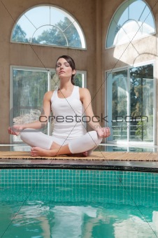 Woman meditating sitting in lotus position