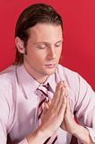 Closeup of a businessman in prayer posture