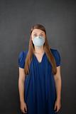 Scared woman wearing surgical mask