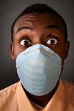 Wide-eyed man in surgical mask