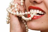 woman smiles showing white teeth and pearly necklace