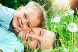 Cute boy with mother lying in the grass