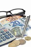 Money, pen, glasses and pocket calculator