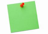 Green post-it with drawing pin