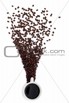 A cup of coffee with coffee beans  scattered around it