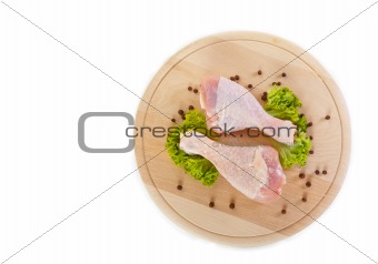 Fresh raw chicken legs with green salad 