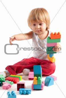 Cute little boy playing with blocks 