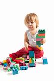 Funny boy playing with blocks 