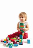Smiling little boy playing with blocks 