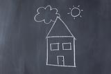 House with sun and cloud on a blackboard
