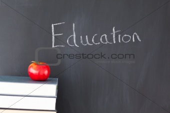 Books an apple and a blackboard with