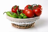 Red tomatoes in basket with green peperoni