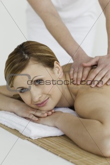 Beautiful blond-haired woman getting a massage