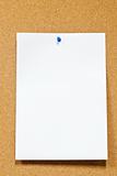 white note paper with thumbtack on corkboard