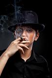 Gangster look. Man with hat and cigar.