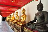Golden sitting Buddha statues in Wat Pho