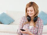Smiling blond-haired woman with headphones and mp3 player