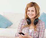 Attractive blond-haired woman with headphones and mp3 player