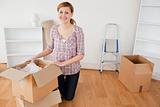Young blond-haired woman preparing to move house 