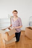 Smiling blond-haired woman preparing to move house 