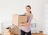 Smiling woman carrying cardboard boxes