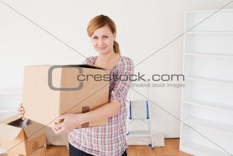 Attractive woman carrying cardboard boxes