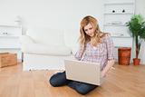 Blond-haired woman surfing on her laptop