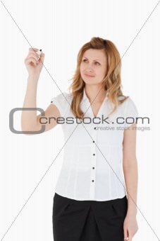 Young woman drawing a scheme looking towards the camera