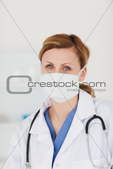 Blond-haired scientist with a mask and a stethoscope posing