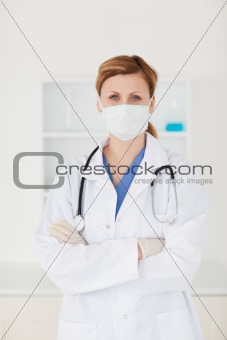 Blond-haired scientist with a mask and a stethoscope looking at 