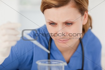 Young female scientist preparing an experiment with a pipette an