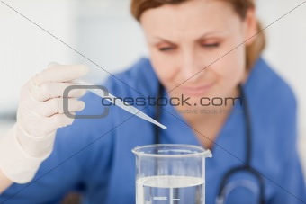 Blond-haired scientist preparing an experiment with a pipette an