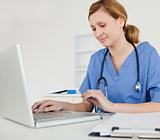 Young female doctor working on her laptop